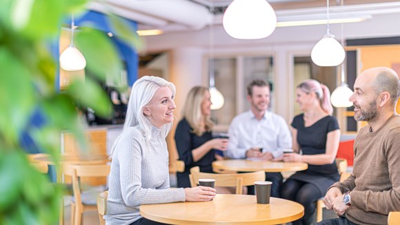 employees having a coffee and laughing