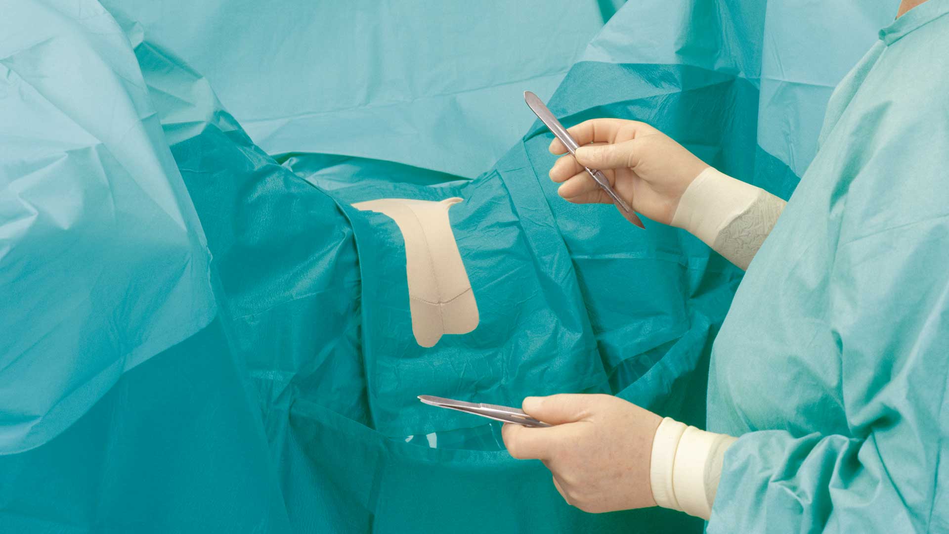 a surgeon using a BARRIER gynaecology drape during an operations