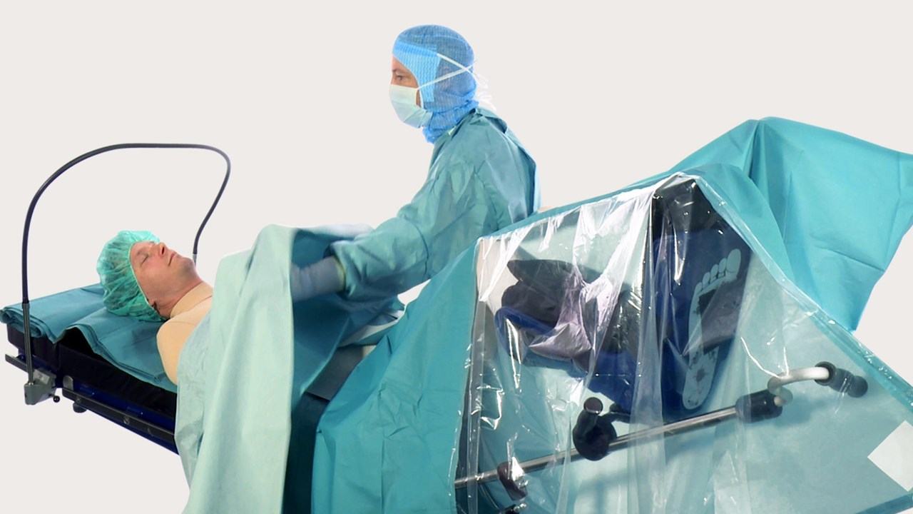 Health care professional draping for a surgical procedure using BARRIER drapes.